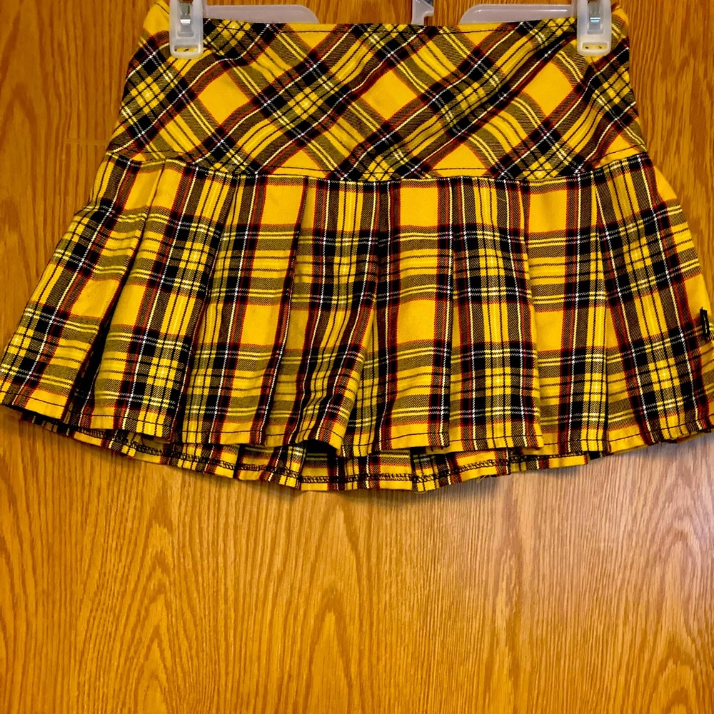 From TRIPP nyc, is mainly yellow with some black and red on it.